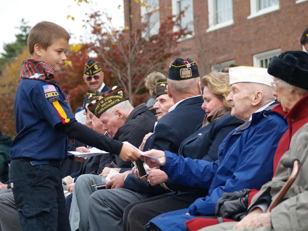 Cub Scount Handing Out Programs